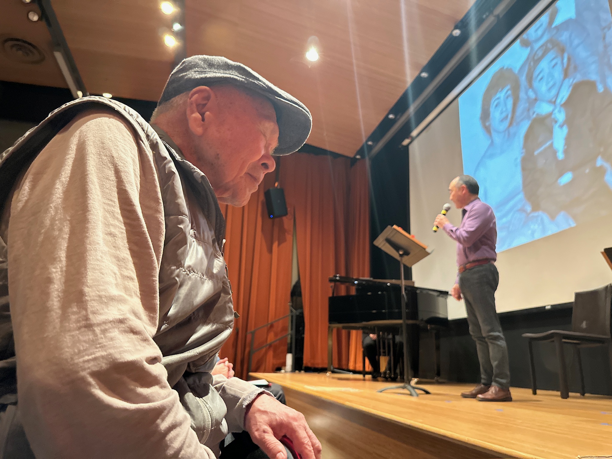 Festival performer on stage with live audience.